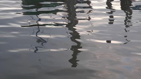 Ripple-Reflection-in-the-River-of-a-Wooden-Boat-Casting-Wavey-Patterns