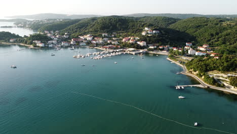 Aerial-View-of-Rab-Island,-Croatia,-Small-Coastal-Town,-Harbor-Marina-and-Calm-Adriatic-Sea-on-Summer-Day,-Drone-Shot