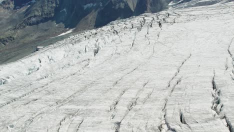 aerial-view-of-ice-glacier-melting-due-to-global-warming,-massive-glacier-with-cracks-in-saas-fee,-switzerland