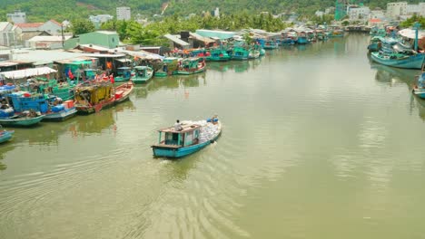 Rural-asian-wooden-boat-sailing-through-dirty-waterway-in-floating-market