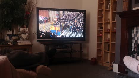 Family-watching-her-Majesty-Queen-Elizabeth-funeral-service-broadcast-on-British-television-at-home