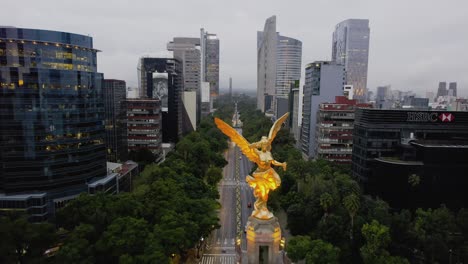 Aerial-view-over-the-Angel-of-Independence-statue-on-cloudy-Reforma-Avenue,-in-Mexico-city