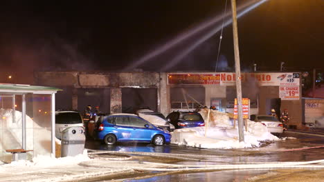 Firefighters-finishing-extinguishing-commercial-building-in-Toronto,-winter-season