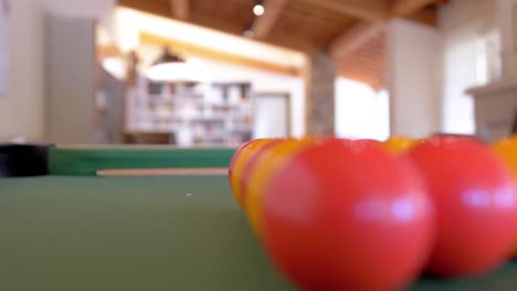 Pool-Ball-set-up-on-the-table-slider-shot-rack-focus-interior-apartment-loft