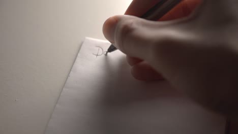 Free-Handwriting-On-A-Blank-White-Pad-Paper-With-A-Black-Ink-Pen---Closeup-Shot