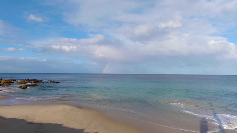 rainbow-in-afternoon-light-on-beach