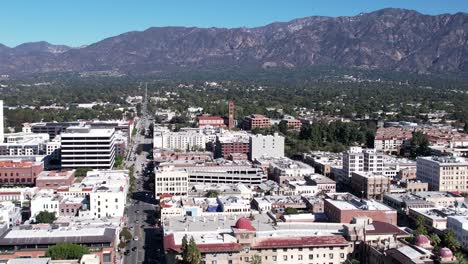 Aerial-view,-bright-clear-day,-downtown-Pasadena-rooftop-buildings,-mountain-scenic-location