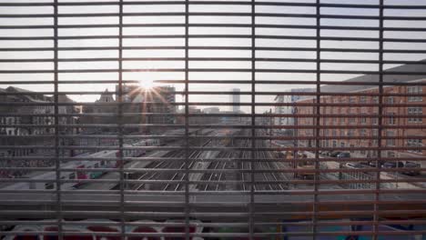 Wide-skyline-view-of-passing-train-at-station-Brussel-Kapellekerk-in-Brussels,-Belgium