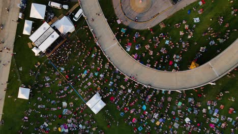 Aerial-view-rotating-above-of-a-open-air-concert-on-the-Big-four-lawn,-in-Louisville,-USA---rising,-overhead,-drone-shot