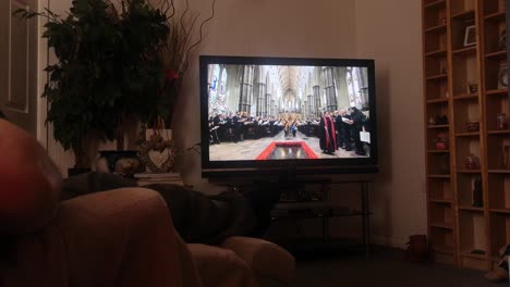 Household-family-watching-Her-Majesty-Queen-Elizabeth-ceremonial-funeral-service-broadcast-on-British-television-at-home