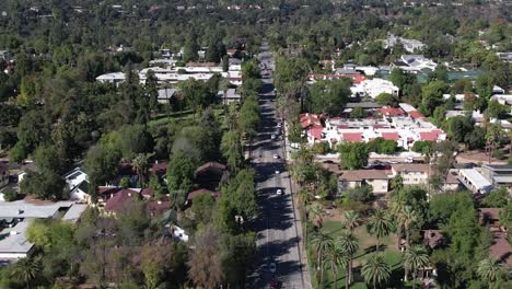 Aerial-view-flying-above-vehicles-driving-long-road-in-Pasadena-Los-Angles-California