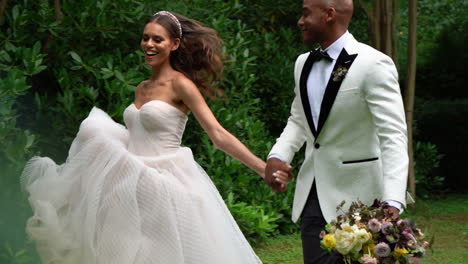 Young-African-American-bride-and-groom-happily-skipping-or-running-on-their-wedding-day