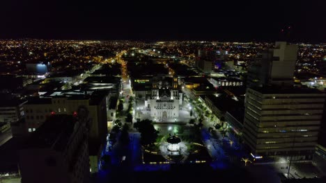Aerial-view-towards-the-Roman-Catholic-Archdiocese-of-Chihuahua,-during-nighttime,-in-Mexico