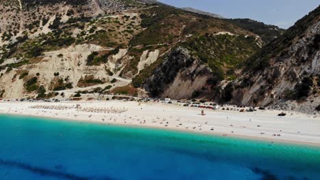 Aerial-View-Of-The-People-At-The-Famous-Myrtos-Beach-In-Kefalonia,-Greece