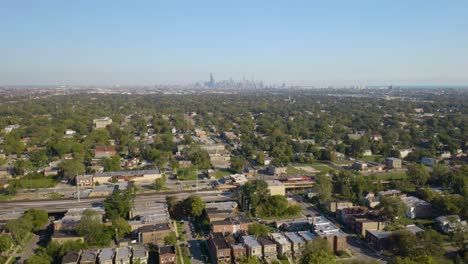 Drone-Descends-in-Chicago's-Southside-with-View-of-Skyline-in-Distance