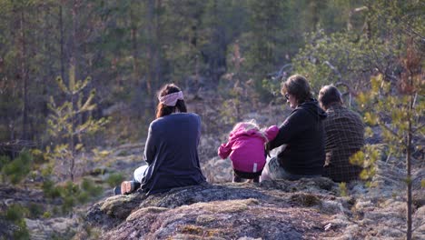 Hiking-family-taking-a-picnic-break-on-a-mountain