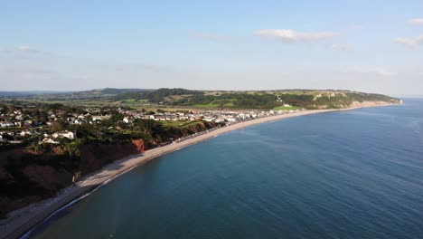 Aerial-panning-left-shot-of-Seaton-Bay-Devon-UK-on-a-beautiful-sunny-day