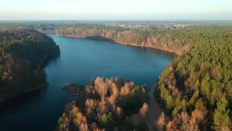 AERIAL:-Panorama-Look-Above-Beautiful-and-Calm-Blue-Lake-and-Green-Pine-Forest