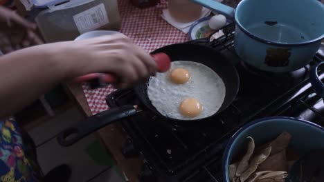 Preparation-of-fried-eggs-and-chilaquiles
