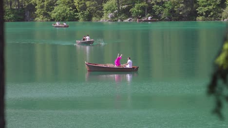 A-woman-changing-her-outfit-on-a-rowing-boat-on-Lake-Braies