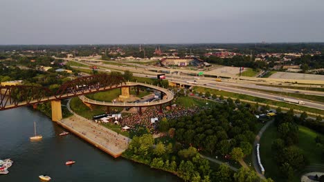 Aerial-view-of-a-open-air-concert,-sunset-in-Louisville,-USA---pan,-drone-shot