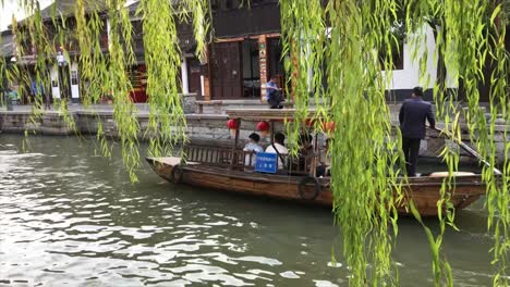 Tour-Group-Travelling-By-Chinese-Traditional-Boat-In-The-Canal