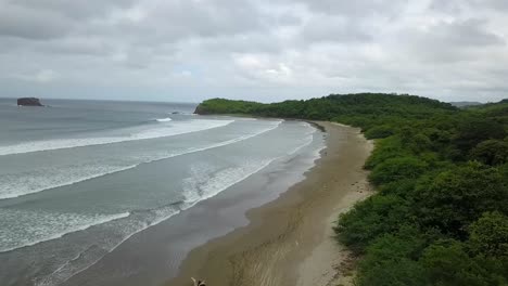 drone-aerial-video-in-nicaragua-beach,-san-juan-del-sur,-palm-,-managua,-rivas,-bicyclist-on-the-beach,-matagalpa,-central-america,-tourism,-america,-nicaragüense