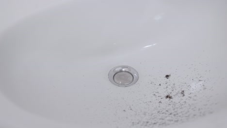 Bathroom-sink-with-hair-from-trimming-beard---slow-motion