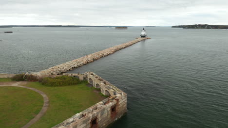 Gorgeous-aerial-view-of-a-Lighthouse-on-Casco-Bay-near-Fort-Preble,-Maine