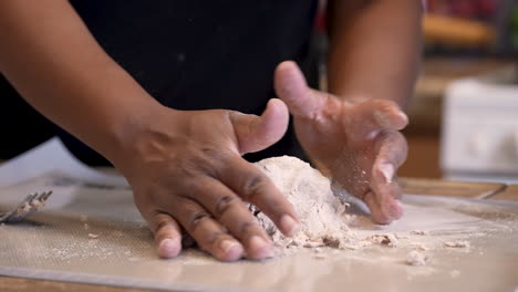 Black-hands-seen-kneading-unleavened-matzah-Passover-bread---isolated-slow-motion