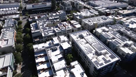 Flying-above-large-Pasadena-apartment-complex-with-solar-panel-rooftops-aerial-view