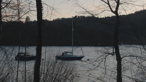 Sailboat-gently-sways-on-a-lake-in-the-Lake-District-UK,-England