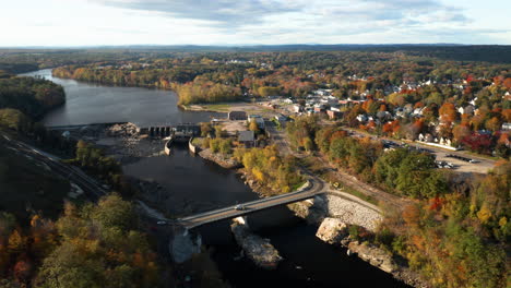 Wide-angle-aerial-shot-of-Lisbon-Falls,-Maine,-and-Androscoggin-River