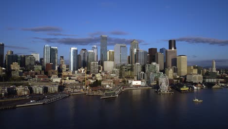 Aerial-view-towards-the-seaside-skyline-of-Seattle-city,-sunny-evening,-in-WA,-USA