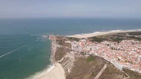 Aerial-backwards-view-of-the-bay-of-Nazare,-also-known-as-"surfer's-paradise