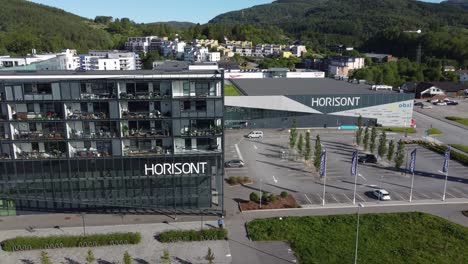 Horisont-shopping-mall-and-apartment-buildings-with-parking-lot-in-Asane-outside-Bergen-Norway---Beautiful-aerial-view-at-sunny-summer-day