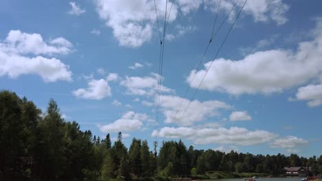 Man-or-Woman-flys-through-shot-on-zip-line-on-Sunny-day