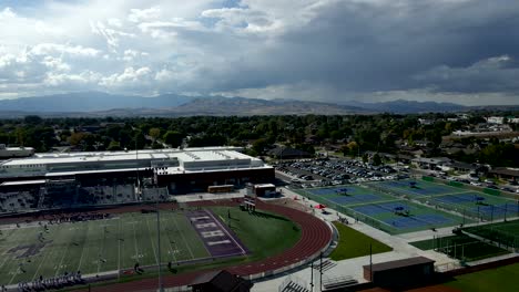 Sports-complex-at-Lehi-High-School-in-Utah,-USA---aerial-pull-back-view