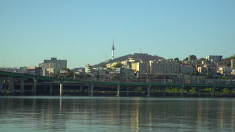 N-Seoul-Tower-or-Namsan-Tower-or-YTN-over-blue-cloudless-sky-from-the-waterfront-of-Han-river-in-Autumn,-Yongsan-gu-South-Korea
