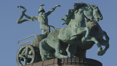 Statue-of-a-man-riding-a-carriage-with-horses-and-snake,-Heroes'-Square-Budapest