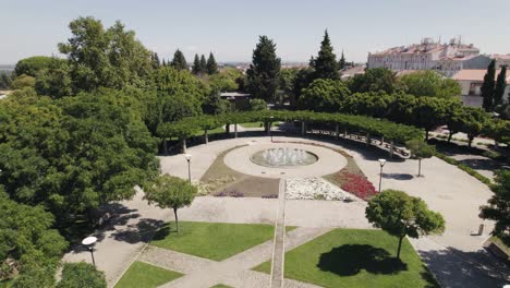 Aerial-circular-view-of-gushing-fountain-in-elegant-garden