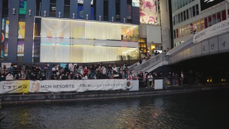 Dotonbori-Canal-in-downtown-Osaka,-People-Line-Streets-for-Halloween-Night