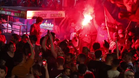 Lighting-red-flare-and-waving-flags,-a-crowd-celebrates-the-election-of-Luiz-Inácio-Lula-da-Silva-in-the-streets-of-Brazil