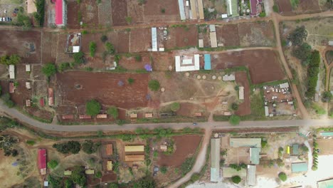 Vista-Aérea-De-Una-Ciudad-Y-Campos-Iluminados-Por-El-Sol,-Hora-Dorada-En-África-Rural---Seguimiento,-Disparo-De-Drones