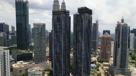 Drone-flying-through-tall-buildings-in-Kuala-Lumpur,-Malaysia