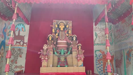Low-angle-shot-of-Goddess-Durga-idol-decorated-at-puja-pandal-in-Kolkata,-West-Bengal-in-India-at-daytime