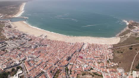 Aerial-backwards-view-of-city-and-seascape
