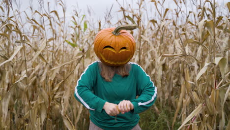 Angry-Woman-With-Pumpkin-Head-Peeling-And-Breaking-Corn-In-The-Field