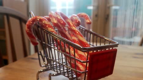 Small-shopping-trolley-filled-with-Christmas-candy-canes-home-delivery-concept-kitchen-idea-pull-away