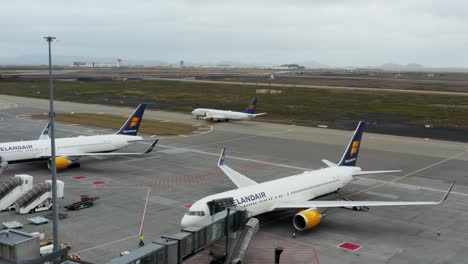 Icelandair-Boeing-airplane-parked-at-gate-of-Keflavik-airport-terminal